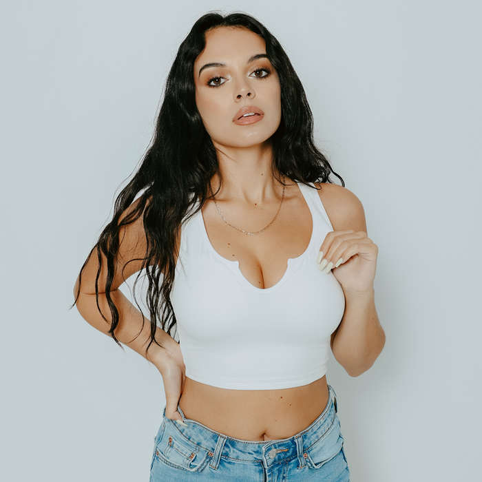 model wearing a white V-cut crop top