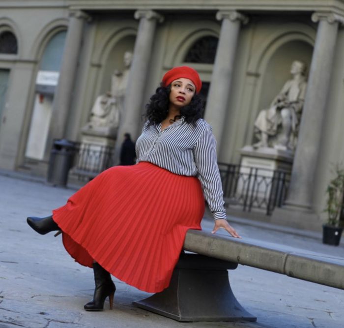 A reviewer wearing the dress in red.
