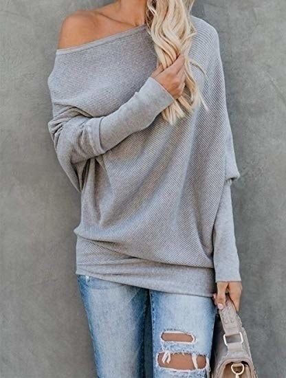 A model is seen in the sweater in grey.