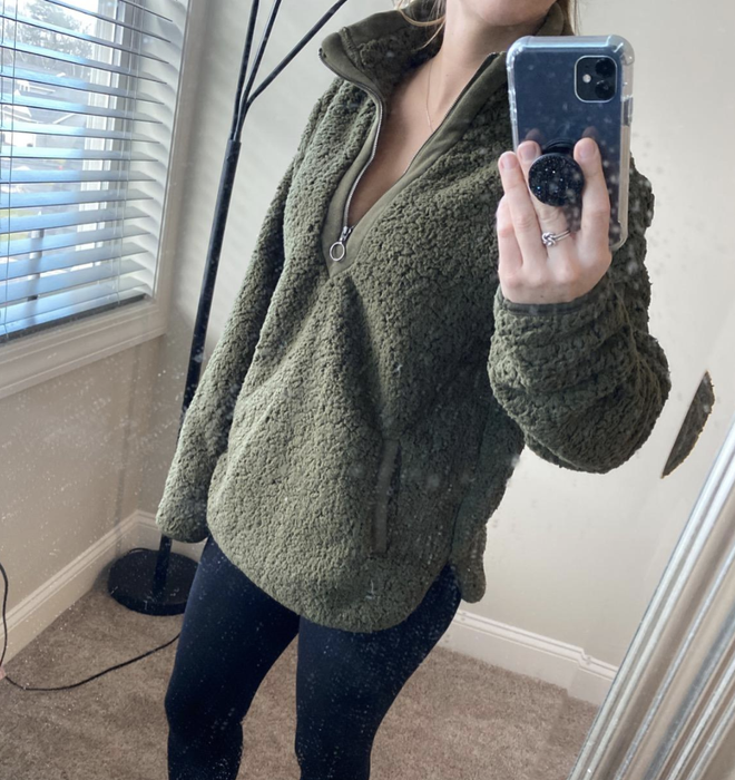A customer photo of them rocking the fleece in a vibrant green shade.