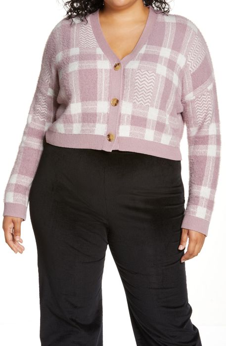 A model styled in the sweater paired with sleek black pants for a chic look.