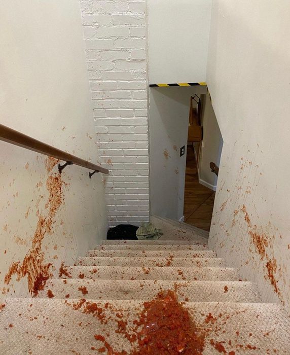 Red salsa spilled all over carpeted stairs.