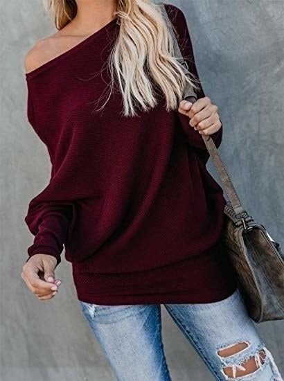 A model is pictured wearing the sweater in burgundy.