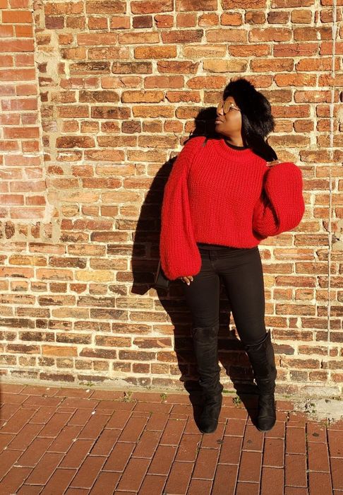 A customer photo of them rocking the sweater in a bold red color.