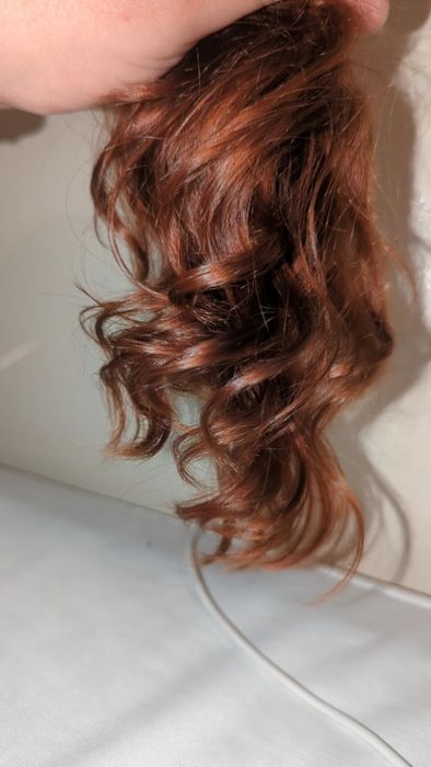 The reviewer showcasing their hair after using the spray.