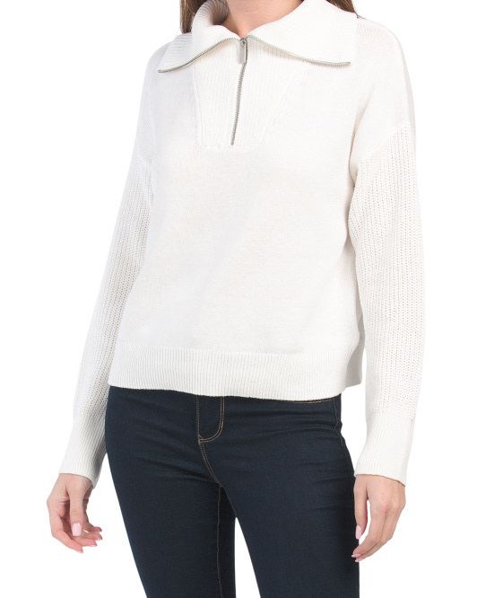 A model wearing the sweater in a soft ivory shade, perfect for layering.