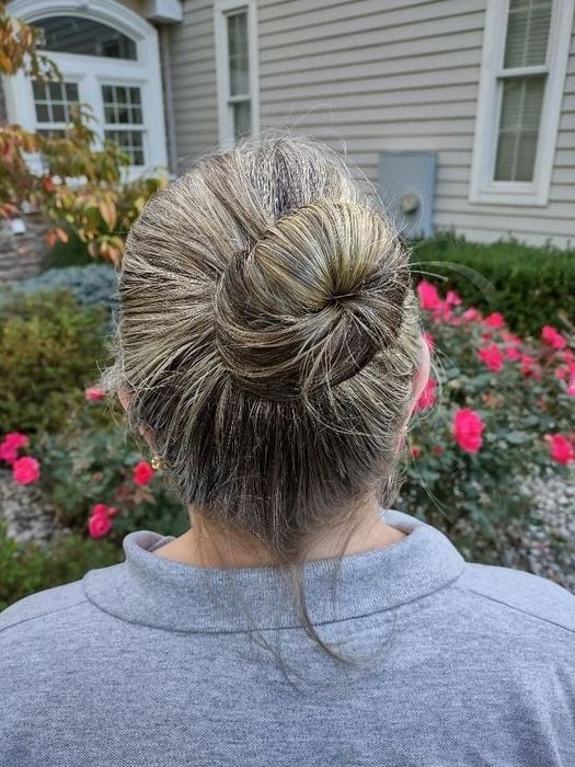 The reviewer’s hair styled in a bun using the spin pins.