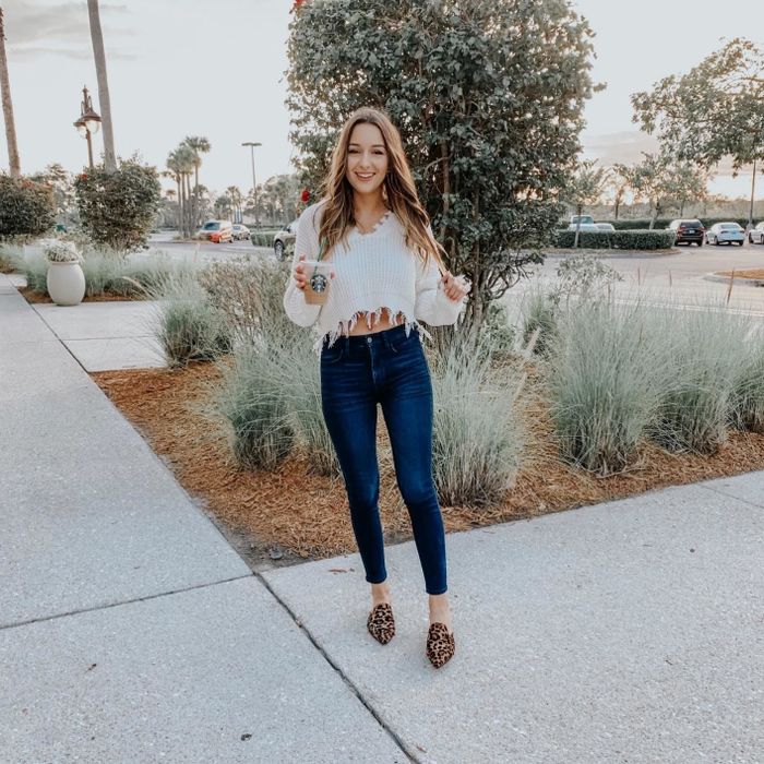 A customer review photo of them wearing the cropped sweater in white.