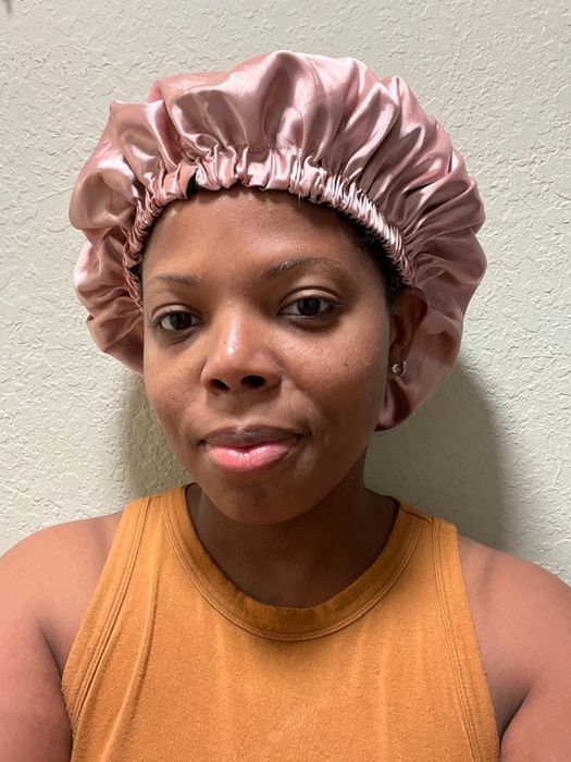 The reviewer models the pink bonnet.