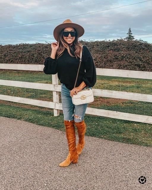 A customer review photo showing them in the black sweater.