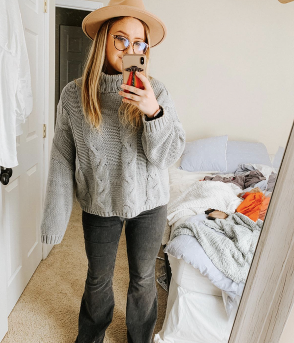 A customer photo of them wearing the sweater in a timeless gray color, exuding warmth and comfort.