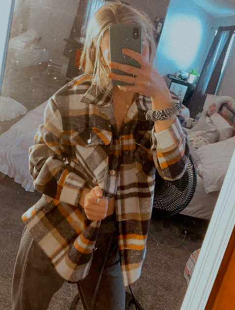 A customer review photo of them wearing the plaid print button-down.