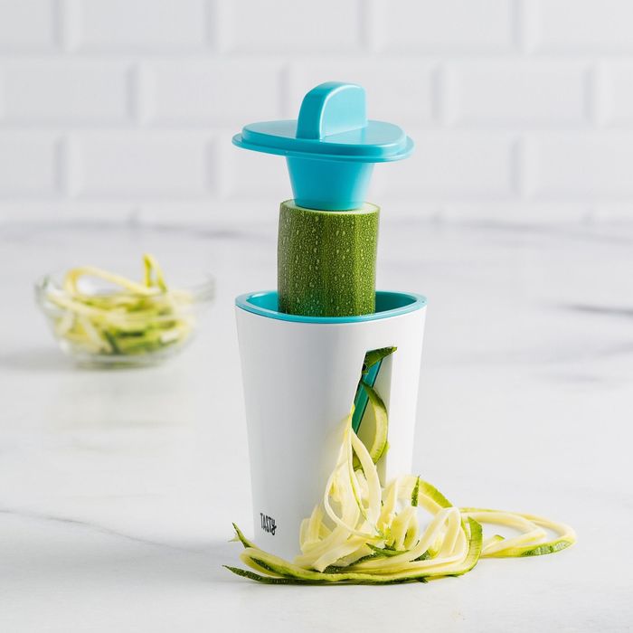 Zucchini spiraling through the spiralizer