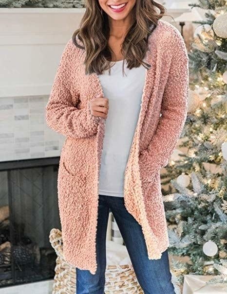 A model is pictured wearing the open cardigan in blush pink.