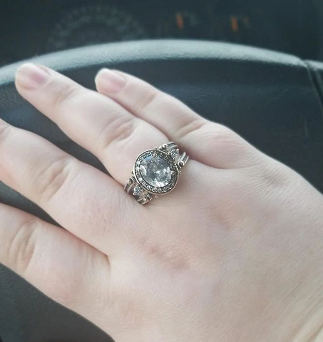 The reviewer is showcasing the reversible ring, displaying the white stone side.