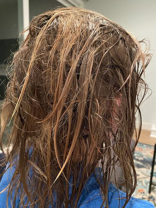 An individual with damp, knotted hair.