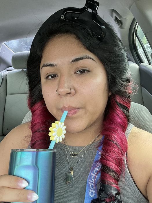 reviewer showcasing the heatless curling rod
