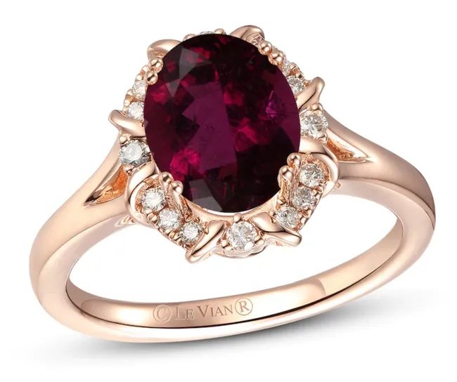 A sapphire-hued stone framed by small diamonds and set on a delicate rose gold band.