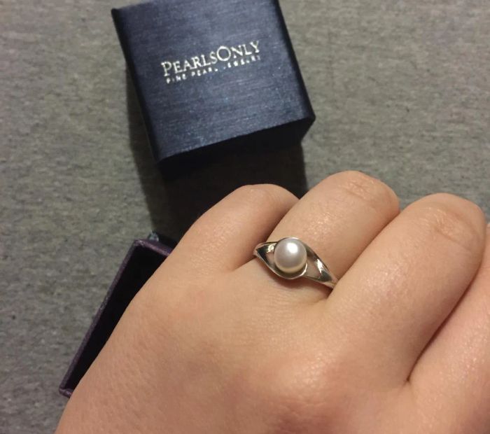 Reviewer showcasing the pearl ring with a silver band