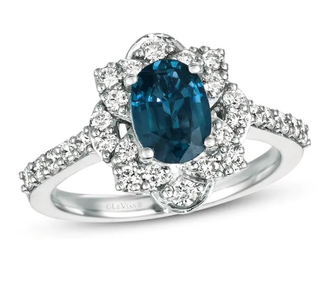 A sapphire stone surrounded by diamonds that continue down the silver band.