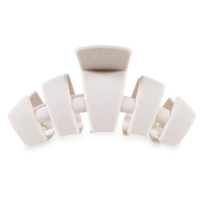 A close-up shot of a minimalist-style open hair claw clip.