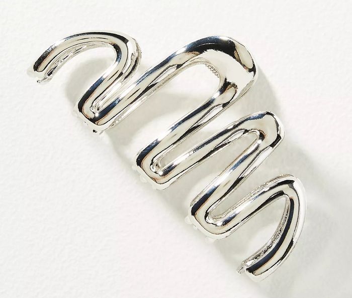 A silver cuff bracelet with a wavy spiral design.
