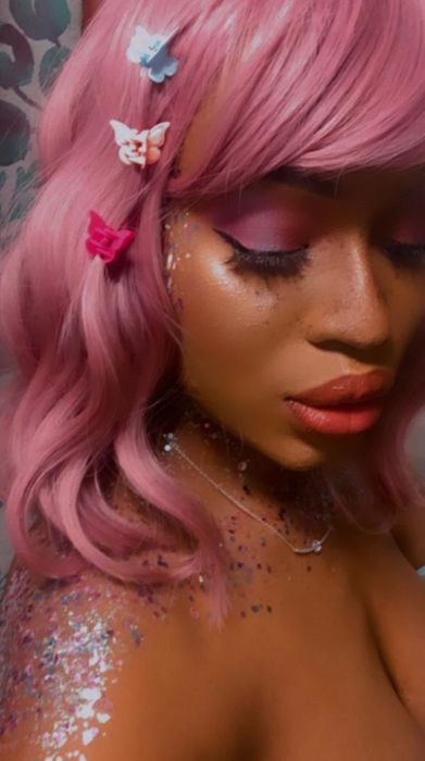 Reviewer photo showing them wearing three butterfly clips in their pink hair