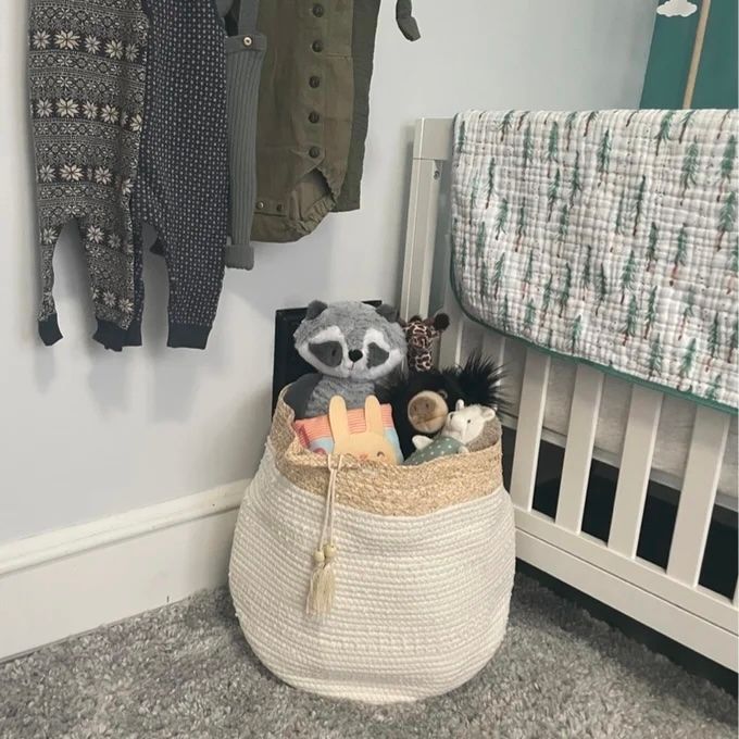 A cream-colored rope basket filled with assorted toys
