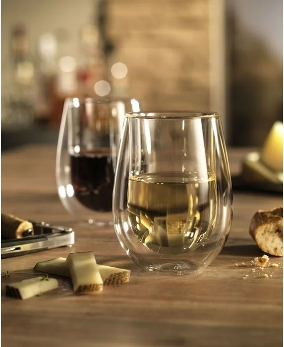 Two stemless double-walled wine glasses filled with wine