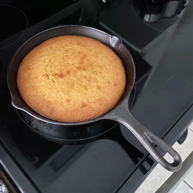 A cast iron skillet containing freshly baked cornbread