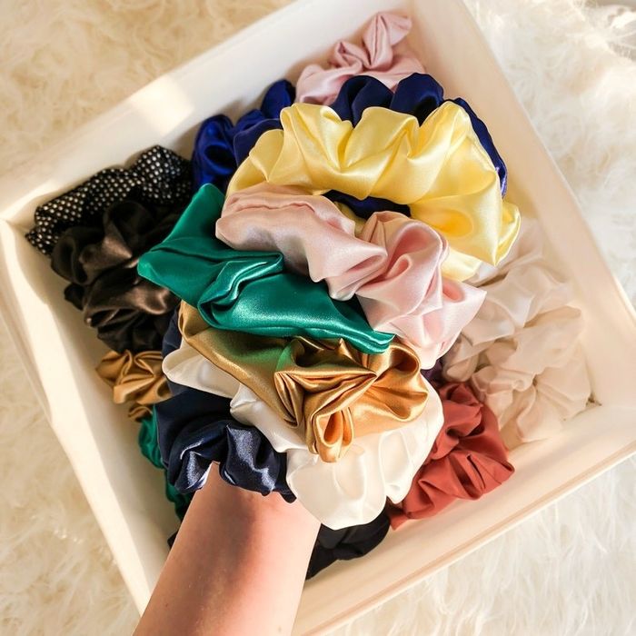 silk scrunchies in various colors worn on the wrist