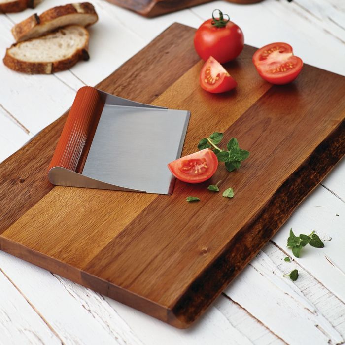 A wooden cutting board featuring freshly sliced tomatoes