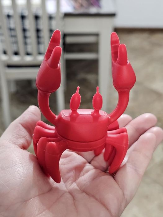 A reviewer showing off the crab-shaped pot clip