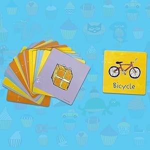 Flashcards featuring images of different items, including a bicycle, spread out on a surface