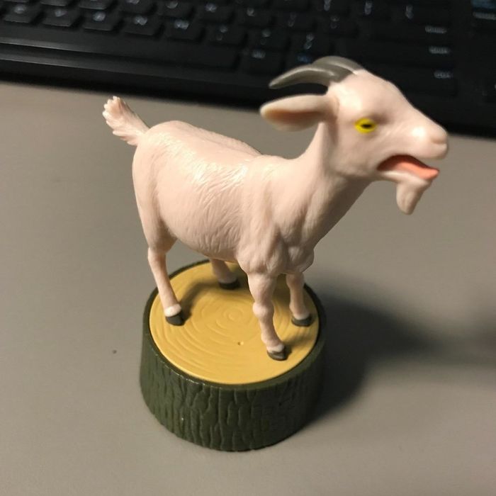 A reviewer's screaming goat figurine displayed on an office desk