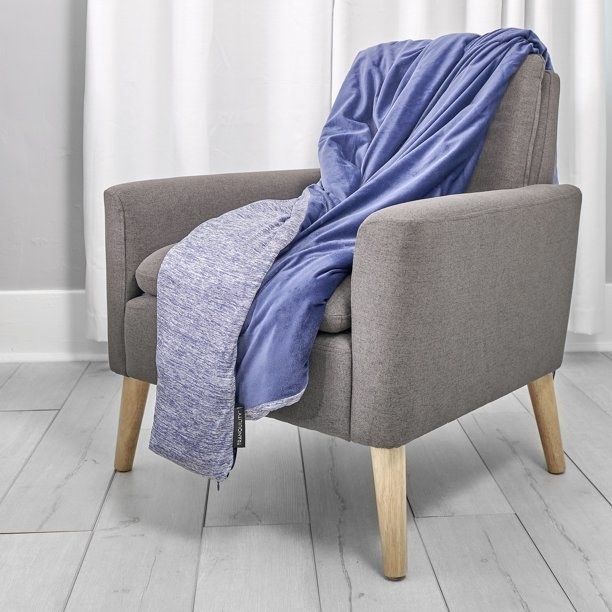 Blue weighted blanket draped over a gray chair.