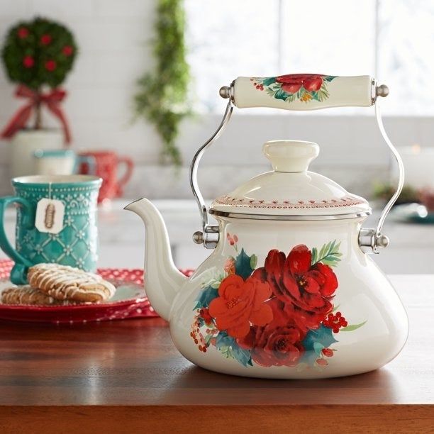 white kettle adorned with red roses