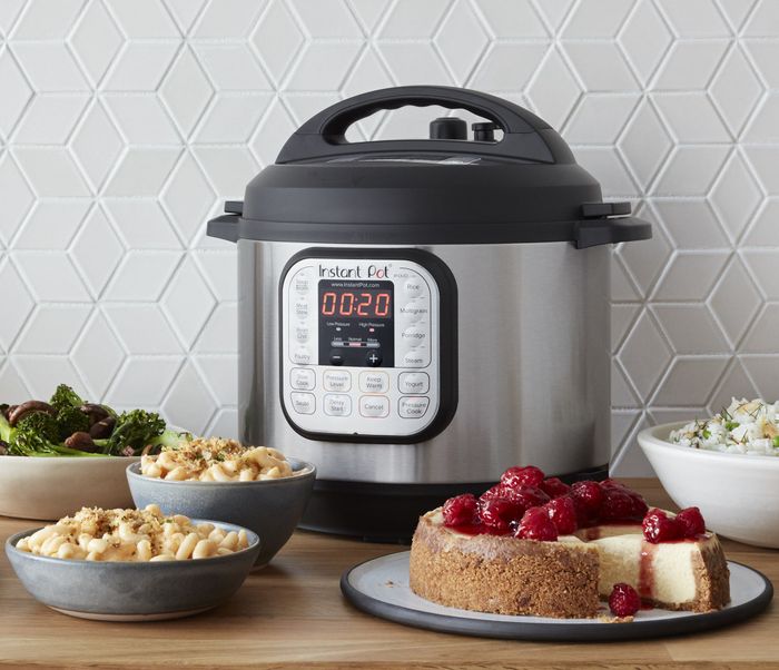 Picture this: an Instant Pot sitting on a kitchen table surrounded by beautifully plated dishes, showcasing its versatility in the kitchen.