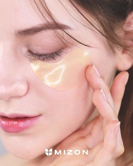 A model with the under-eye mask applied, looking refreshed