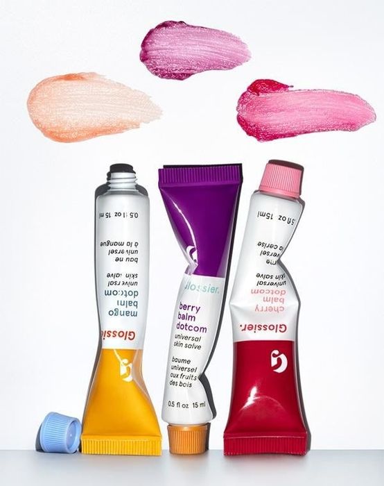 Three Glossier lip balm tubes.
