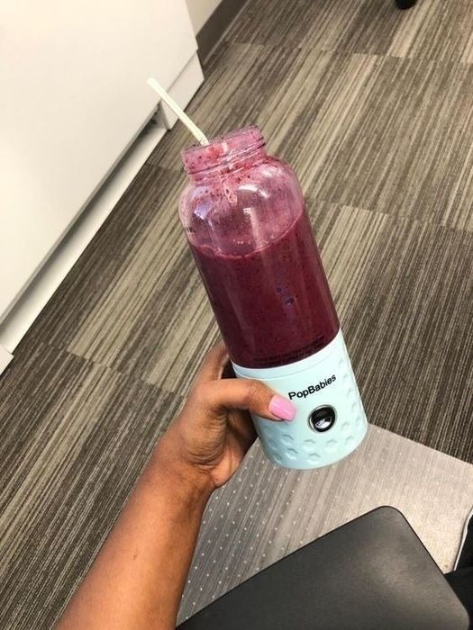 The same reviewer’s personal blender now full of berries blended into a delicious smoothie.