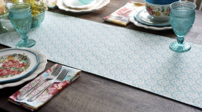 The reverse side of the table runner features a white and blue checkered pattern.