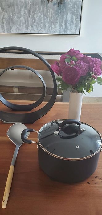A reviewer showcases the Goodful non-stick Dutch oven and ladle.