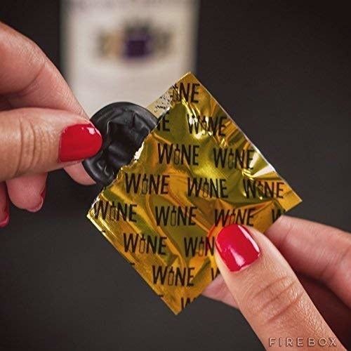 A model peeling back a black wine condom from its packaging
