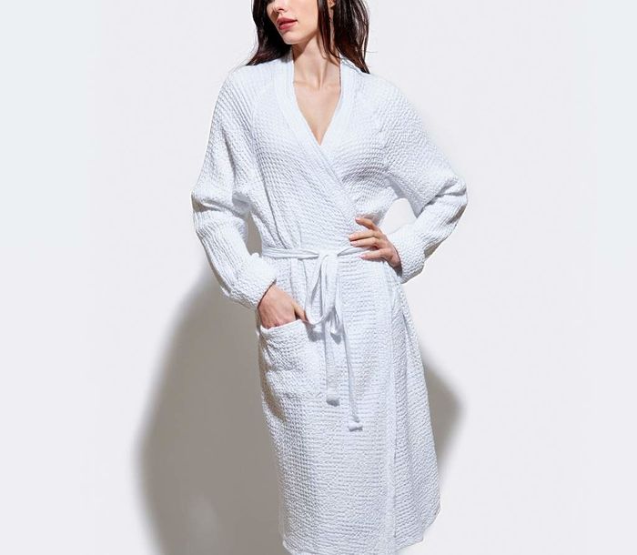 A model showing off the honeycomb bathrobe in all its cozy glory.