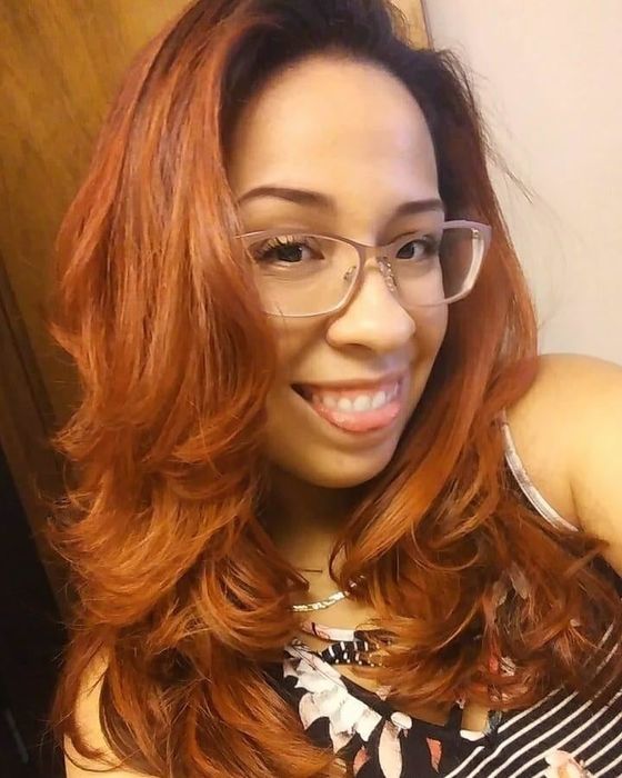 A reviewer proudly showing off their hair after straightening.