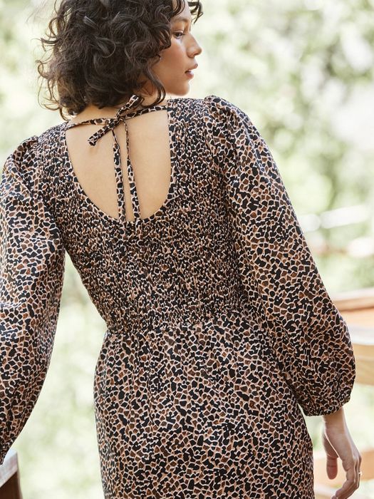 A model showcasing the back of the dress.