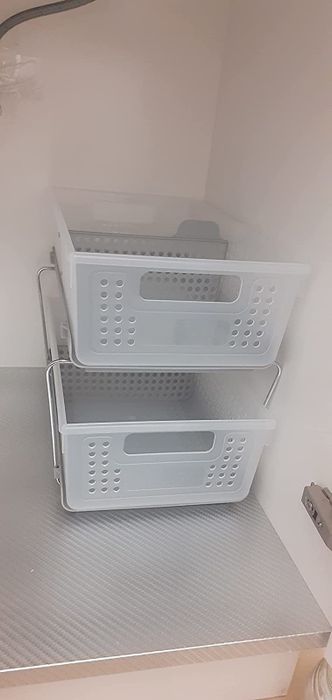 A reviewer's photo of the empty organizer placed inside a cabinet, ready to transform cluttered spaces into tidy ones.