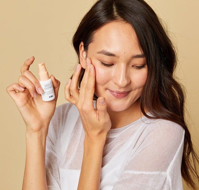 A model demonstrating the application of the acne spot treatment.