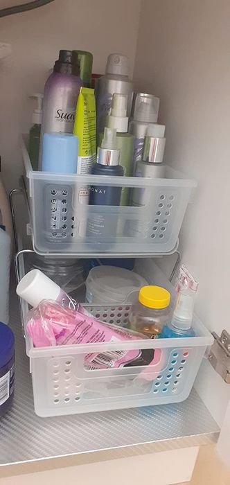 A photo from a reviewer showing the organizer placed in the same area, now stocked with various bathroom essentials.